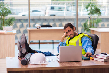 Young male architect working in the office