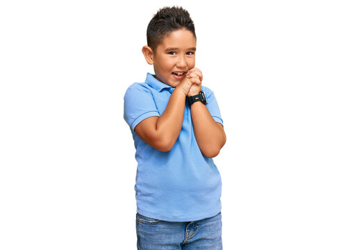 Little boy hispanic kid wearing casual clothes laughing nervous and excited with hands on chin looking to the side