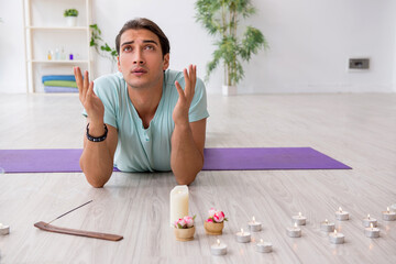 Young man during yoga session at home