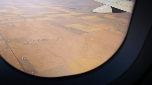 Airplane Flying Over Fields Of Farmland Crops.