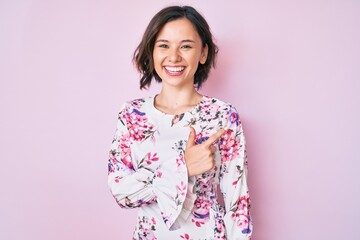 Young beautiful woman wearing casual clothes smiling cheerful pointing with hand and finger up to the side