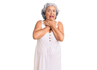 Senior woman with gray hair wearing casual clothes shouting and suffocate because painful strangle. health problem. asphyxiate and suicide concept.