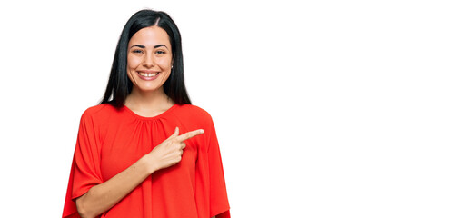 Beautiful young woman wearing casual clothes cheerful with a smile on face pointing with hand and finger up to the side with happy and natural expression