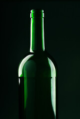Close-up of a green wine bottle on a black background