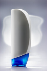 Close-up of white shampoo bottle on a light background