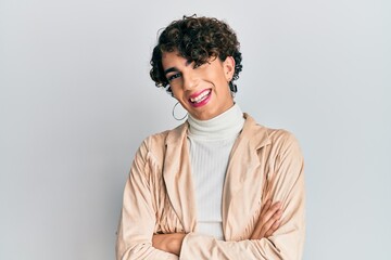 Young man wearing woman make up and woman clothes happy face smiling with crossed arms looking at...
