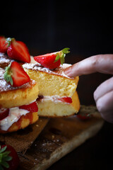 Soft focus. Victoria sponge cake. The famous dessert biscuit with strawberries.
