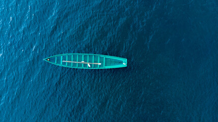 Naklejka na ściany i meble Boat in the Atlantic Ocean from a drone