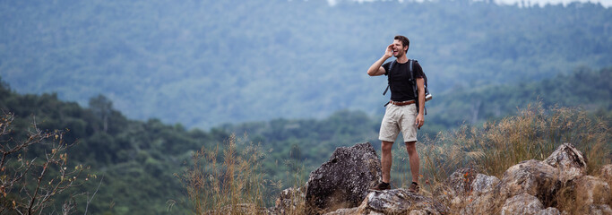 Man backpacker nature travel, standing and shout on mountain. Hiking trip concept. - obrazy, fototapety, plakaty
