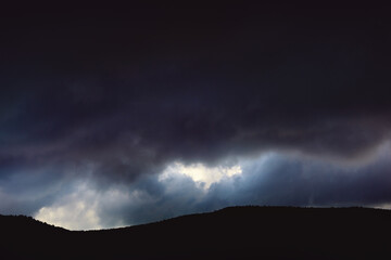 Panoramic view of the clouds in the mountains at sunrise.