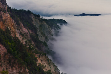 Panoramic view of the clouds in the mountains at sunrise.