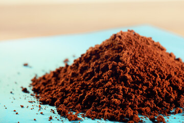 Close-up of instant coffee heap on blue background
