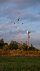 Base station and high voltage line during sunset