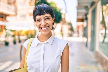 Young woman with short hair smiling happy outdoors