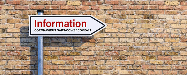 Obraz premium street sign with message INFORMATION regarding the coronavirus SARS-COV-2, COVID-19 in front of a brick wall