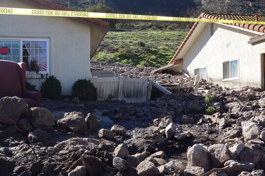 Mudslides destroys house and homes with rocks and debris in suburban area of California