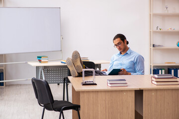 Young male teacher in the classroom