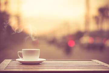 Coffee espresso on wood table nature background in garden, warm tone