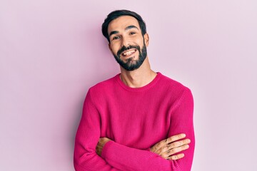 Young hispanic man wearing casual clothes happy face smiling with crossed arms looking at the camera. positive person.