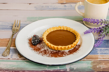 Chocolate tart whit berries in wood background