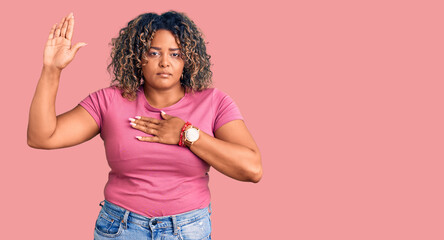 Young african american plus size woman wearing casual clothes swearing with hand on chest and open palm, making a loyalty promise oath