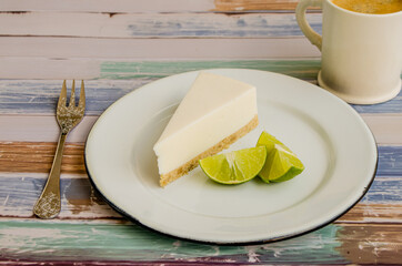 Slice of lemon pie with coffee on wooden background
