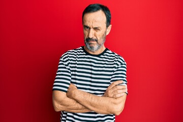 Middle age hispanic man wearing casual clothes skeptic and nervous, frowning upset because of...
