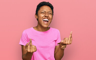 Young african american woman wearing casual clothes showing middle finger doing fuck you bad...