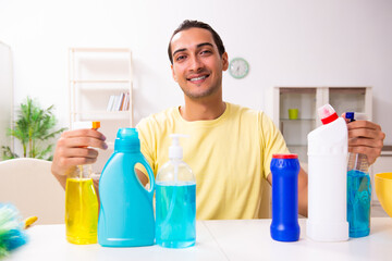 Young male contractor doing housework at home