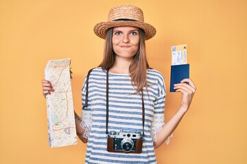 Beautiful caucasian tourist woman holding city map and passport skeptic and nervous, frowning upset because of problem. negative person.