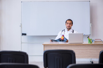 Young male doctor radiologist giving seminar in the classroom