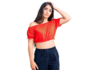 Brunette teenager girl wearing casual clothes confuse and wonder about question. uncertain with doubt, thinking with hand on head. pensive concept.