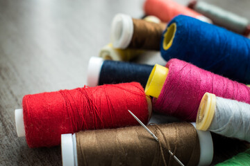 Many different colorful threads on a table in a tailor shop