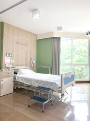 hospital or patient room with bright light. patient bed or stretcher and foot stool