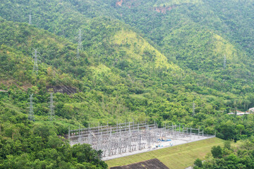 Fototapeta na wymiar High voltage power distribution substation plant among mountain and forest in nature, Thailand.