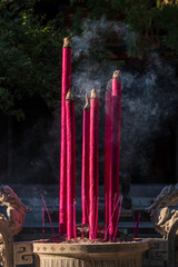 red burning joss sticks with smoke
