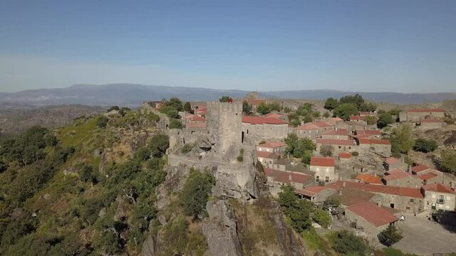 An aerial view of the beautiful Castle of Sortelha surrounded by trees in Portugal