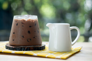 A cup of iced Mocha coffee on wood table in garden