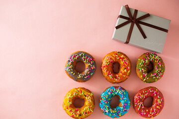 gift box next to colorful donuts