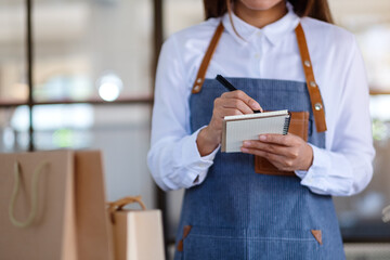 Closeup image of a female entrepreneur checking orders from customer