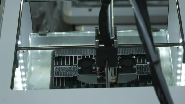 3D printer working. Fused deposition modeling, FDM. 3D printer printing an object from plastic. Automatic three dimensional 3d printer performs plastic. Progressive additive technology for 3d printing
