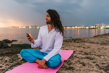 Man in Yoga Mat Using Phone