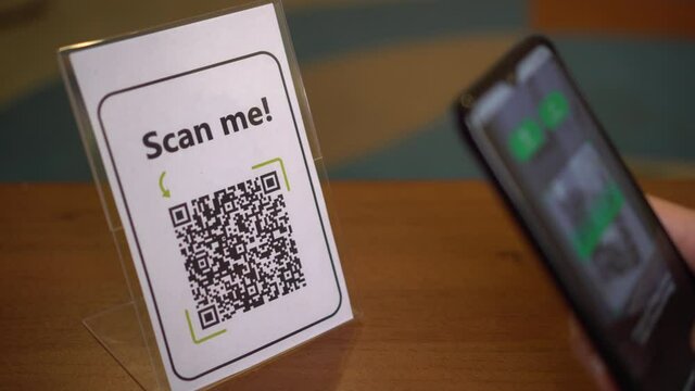 Scanning the QR code on the display using a smartphone. Internet URL, encrypted data, e-ticket, menu, contactless payment, citizen ID card, pass