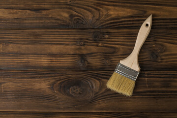 Brush with large bristles on a tinted wooden background.