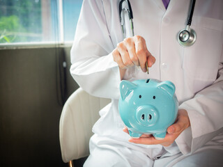 female doctor  is holding piggy bank in hand and stethoscope examining saving money , saving money for healthcare and financial concept copy-space white background,