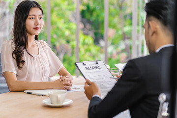 Young Asian woman graduate interviewing with two manager with positive motion in meeting...