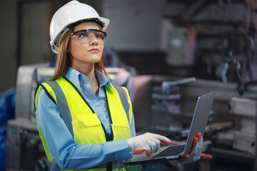 Asian factory worker woman hold laptop
