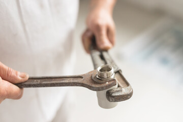 Side view of two keys wrench and balloon in hands