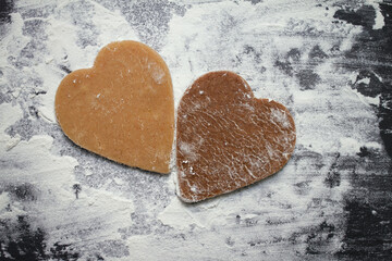 two different hearts, light and dark, made from raw cookie dough made by hand