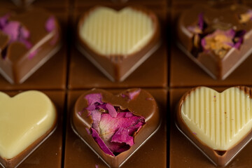 Horizontal close-up macro shot of heart shaped chocolate. Gift for lover. Love or valentine's day concept. Belgian chocolate.